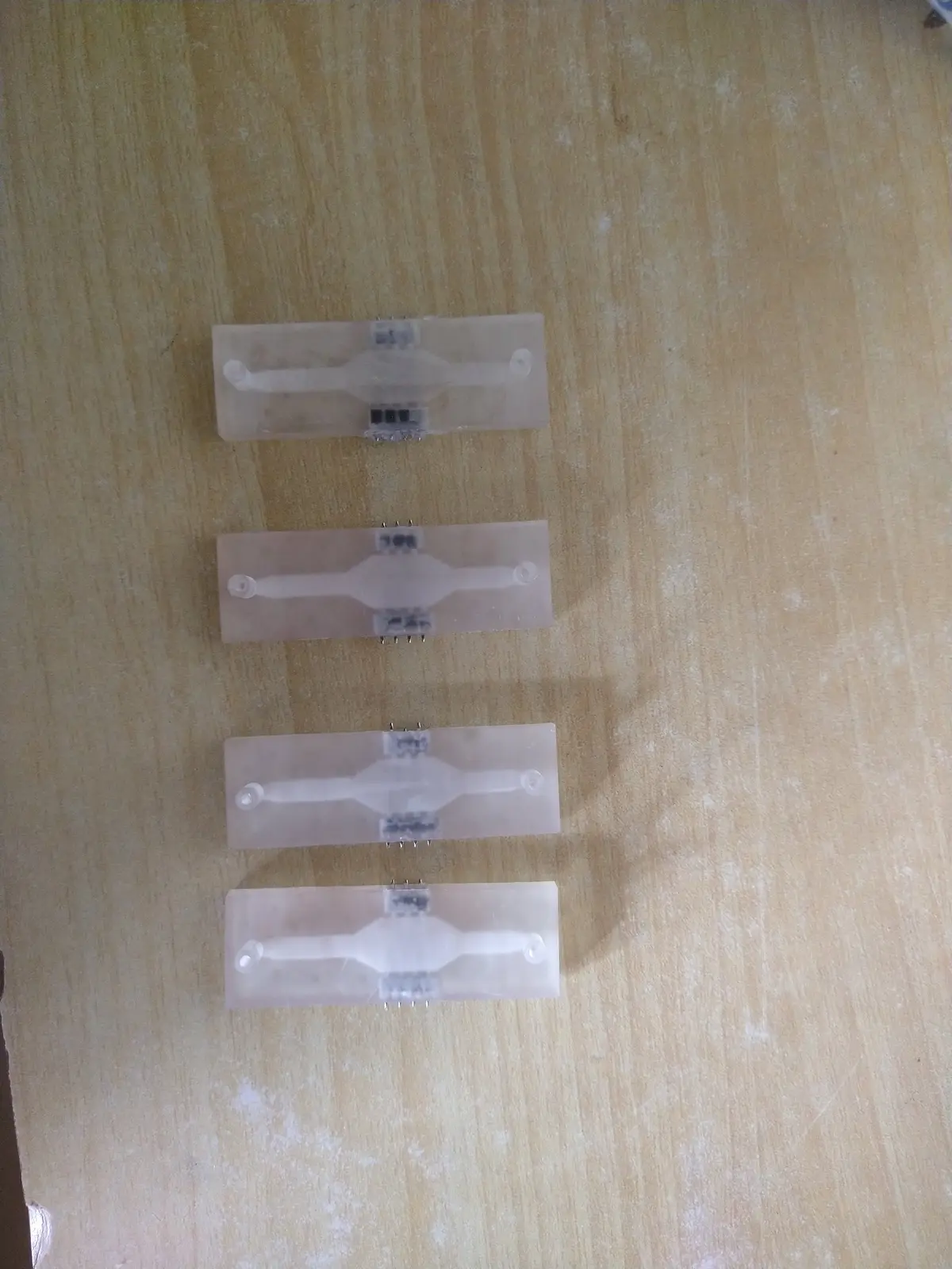 SLA-printed microfluidic cells with electrodes bonded in, for flow measurements on live cell culture.