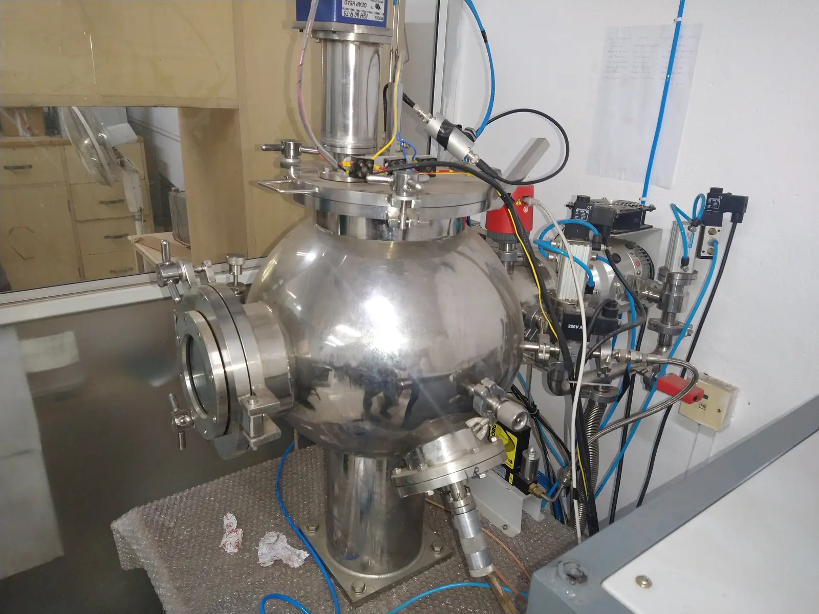 The RF/DC sputtering chamber — stainless bell, viewport, turbo and gas lines. It arrived dead; this is before the teardown.